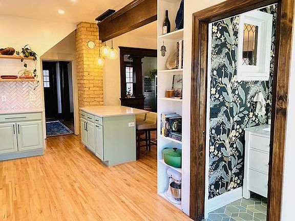 Looking from kitchen into dining room. Built in shelves great for storage of large kitchen items.