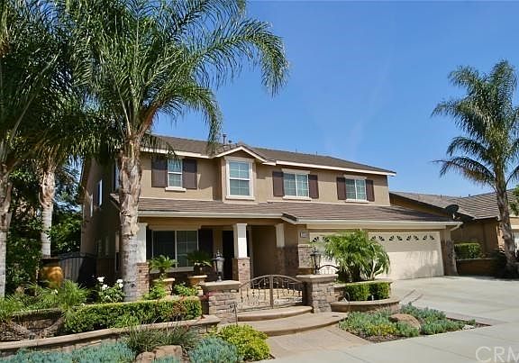 Love the palm trees and courtyard in the front of this home!