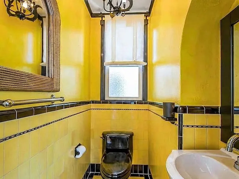 Main level half Bathroom with original period details and tiling.