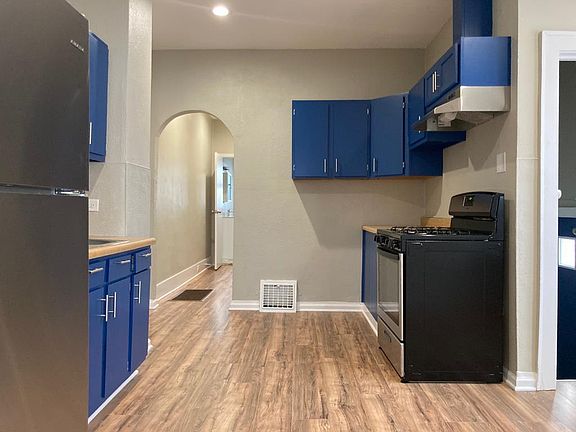 Kitchen with side entrance and basement.