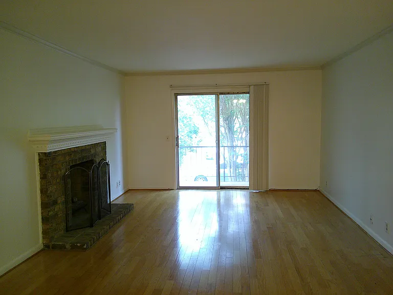 Great living room with hardwood floors and private balcony. Fireplace is for cosmetic purposes only.