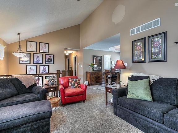 The view of the living room looking into the kitchen and down the hall.