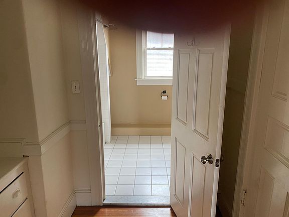 hallway leading to bathroom, built in drawers