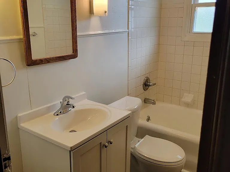 Bathroom with medicine cabinet, new sink, faucet and toilet.