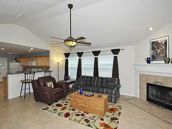 Gorgeous corner gas starter fireplace with mantle. Notice the detail in the beautiful tile floors ar