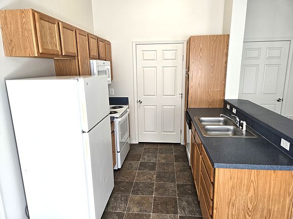 Kitchen, with laundry room behind the door.