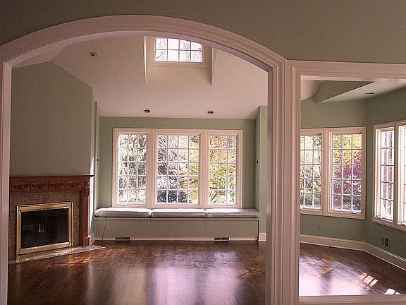 Family Room with cathedral ceiling, fireplace, and two walls of windows