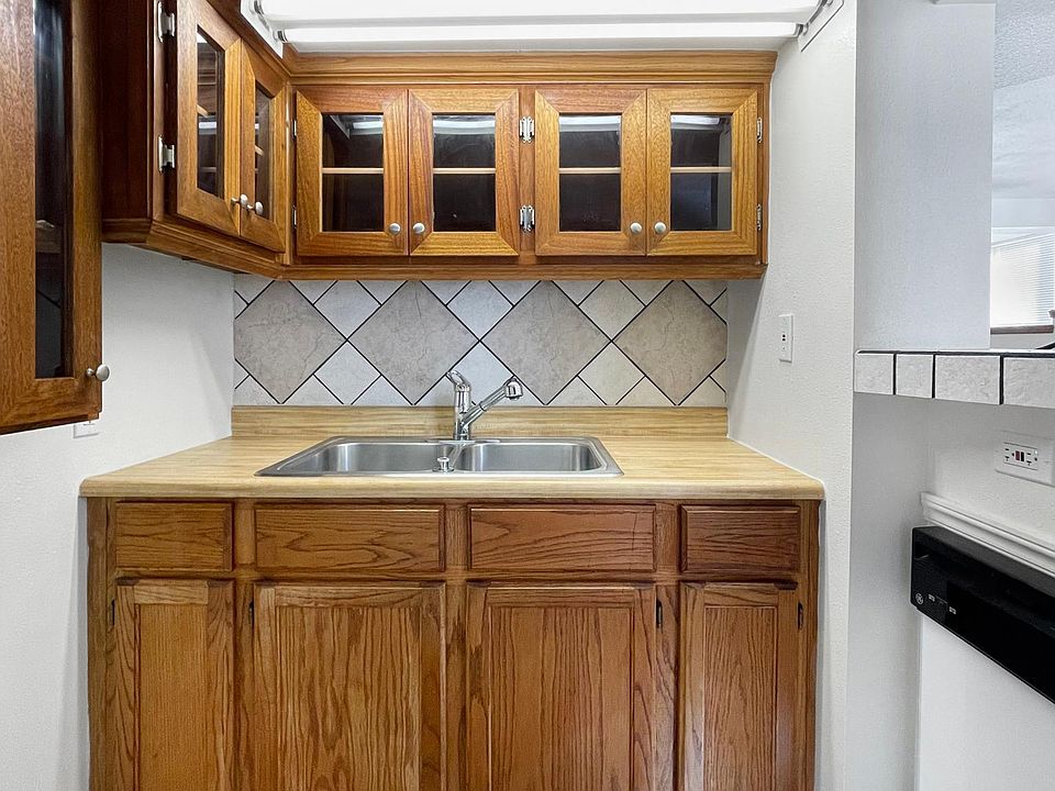 Cute and artsy kitchen with dishwasher.