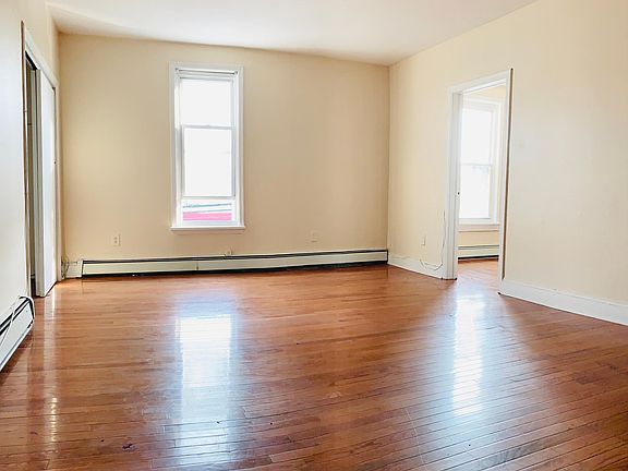 Living room - view from the entrance, big closet door to the left and smaller bedroom to the right