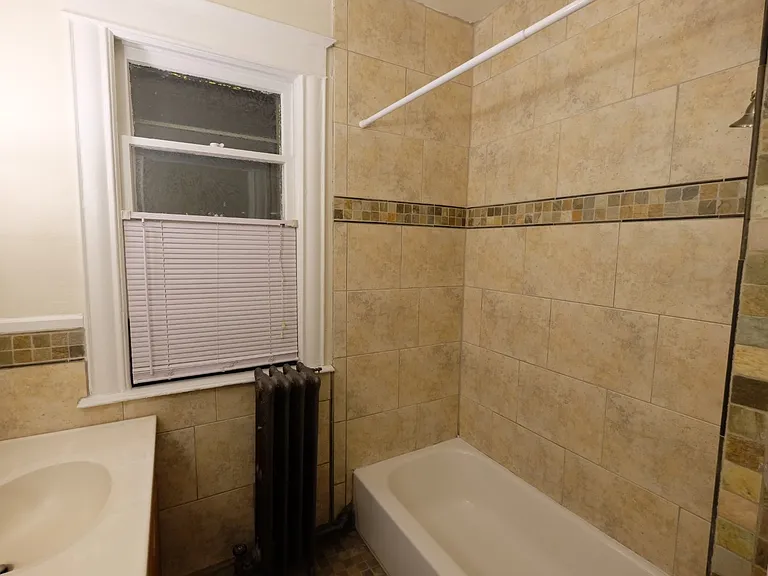 Elevate your living at Central Lakes of Uptown. This modern bathroom features stylish tile work and ample natural light, creating a serene retreat. Don't miss out on this exceptional opportunitya"schedule your tour today!