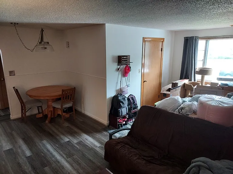 Living/Dining room w/ new flooring throughout.
