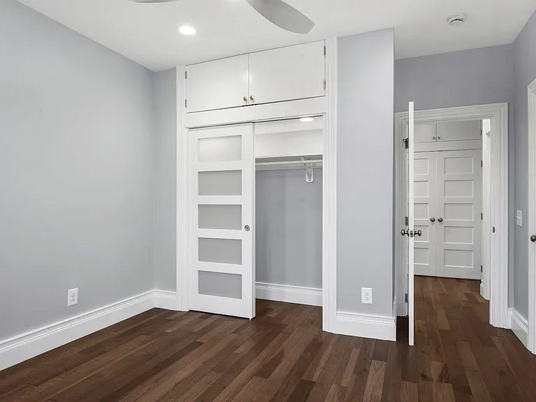 Street-side master bedroom closet (7 feet wide), with storage above. 10 foot ceiling heights used to get maximum storage use.