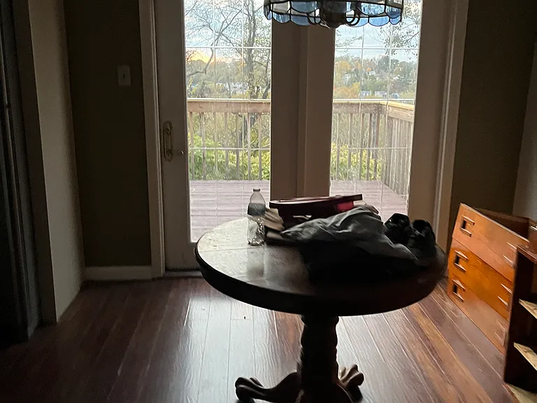 Dining room with French doors leading out to large deck, perfect for morning coffee or dining while taking in fabulous sunsets!
