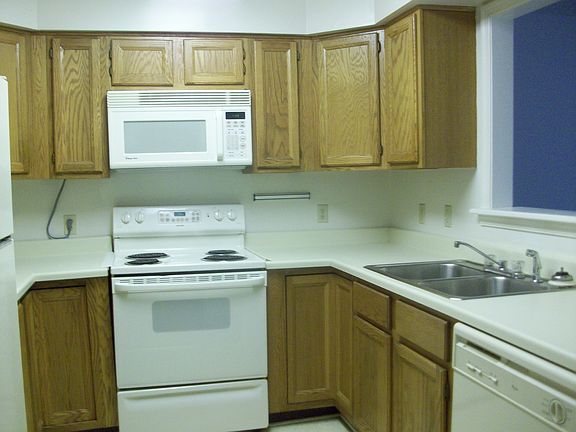 kitchen has range dishwasher microwave and fridge