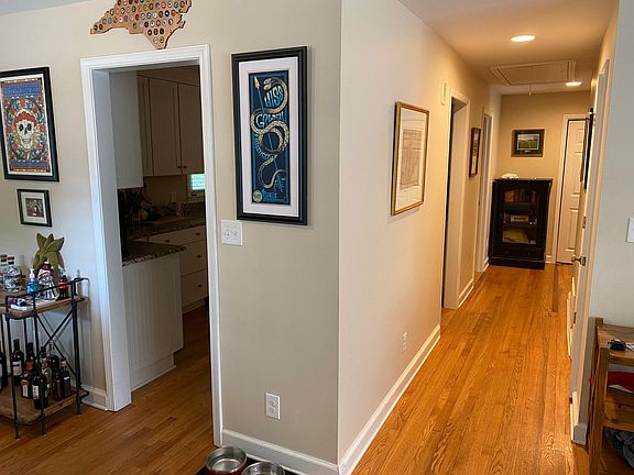 Entry looking down hallway to bedrooms and entrance to kitchen