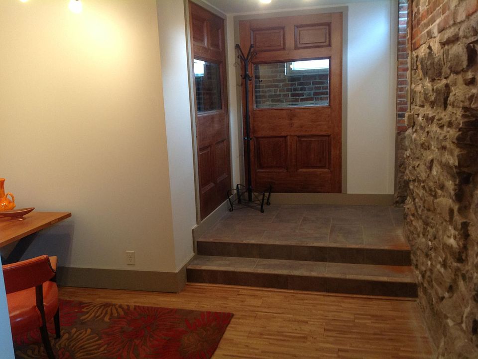 Tiled foyer features two statement wall created from doors salvaged from a period home.
