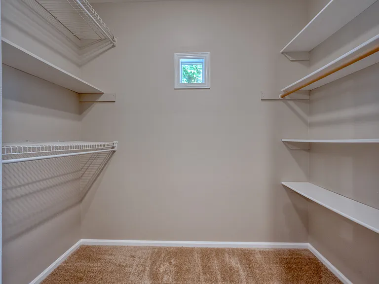 Primary bedroom walk in closet