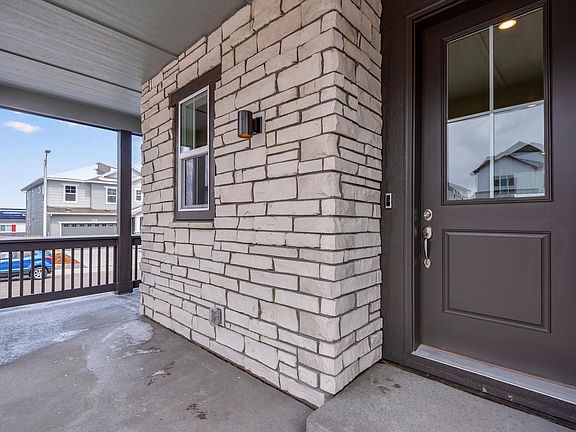 Covered wrap-around front porch and front entry detail