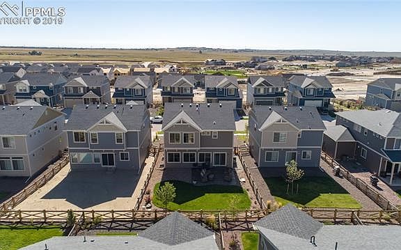 Aerial rear view of home showing nice landscaping and fenced back yard