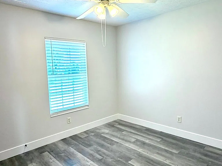 Bright and airy secondary bedroom with ceiling fan