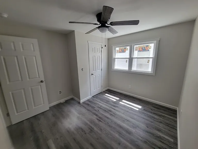 Bedroom #2 with closet and ceiling fan.
