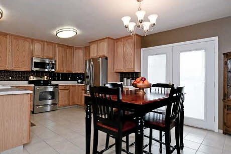 Kitchen with solid surface countertops and stainless steel a