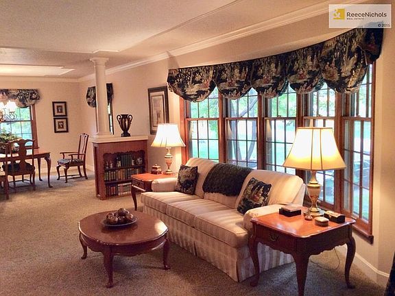 Living room features bay window & built in bookcases.