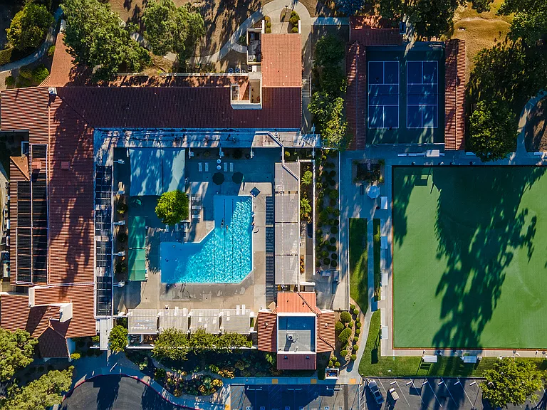 Residents enjoy access to a swimming pool and spa, pickleball and tennis courts, lawn bowling, fitness center, library, pottery studio, card rooms, numerous clubs and social activities, walking and hiking groups, and the nearby Oaks North Golf Course.