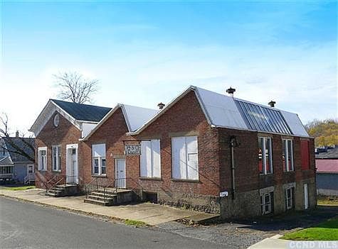 Street facade showing driveway access to the lower level.