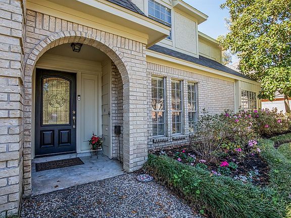 Handsome black front door with leaded glass star inset.
