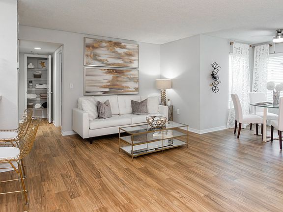 This open-concept layout features a cozy living room, sunlit dining nook, and a stylish breakfast bar.
