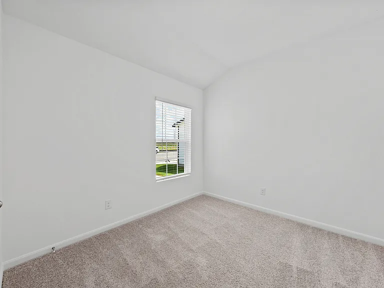 Additional bedroom with lush carpet.