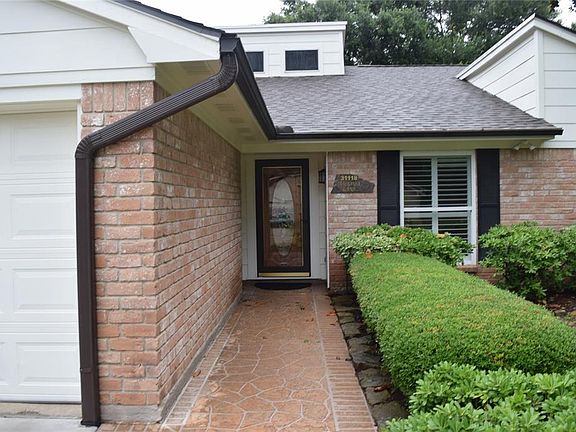 Welcome family and friends. Fragstone walkway adds a great touch with it's well cared for shrubbery lining it.