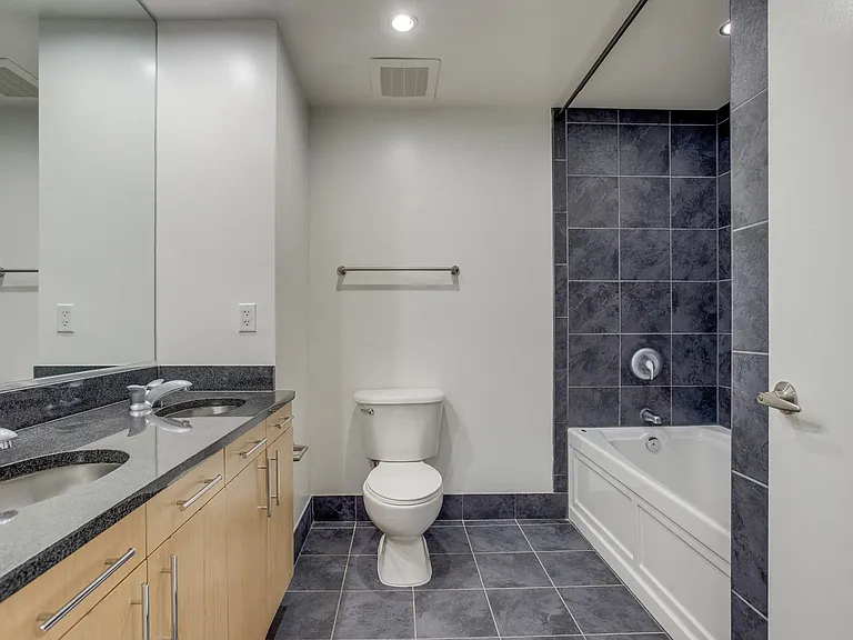 Modern bathroom design with tile-surrounded soaking tubs in select homes