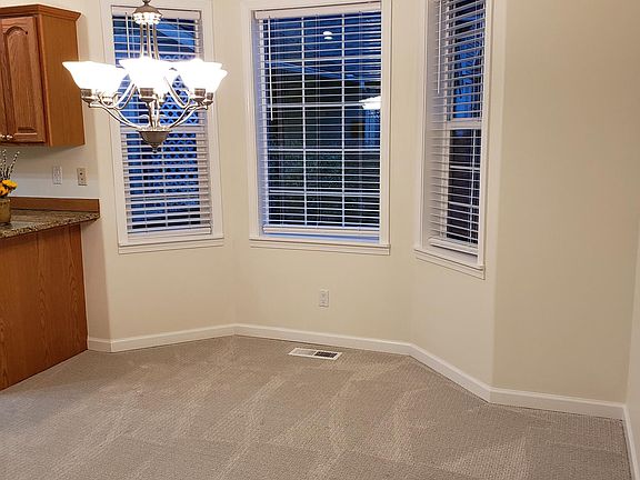 Dining room - light and bright with bank of bay windows.