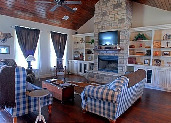 The living room offers plenty of room for entertaining guests yet is comfortable setting for a quiet evening with just family.  The custom shelving has beadboard backing and plenty of storage for all those collectibles and family photos.