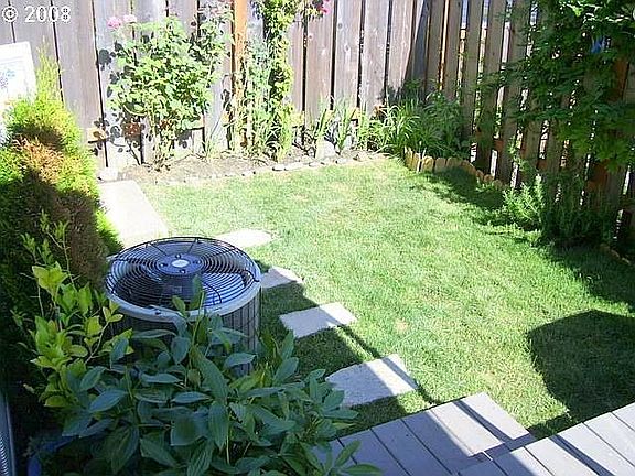 low maintenance yard with large composite deck and retractable awning