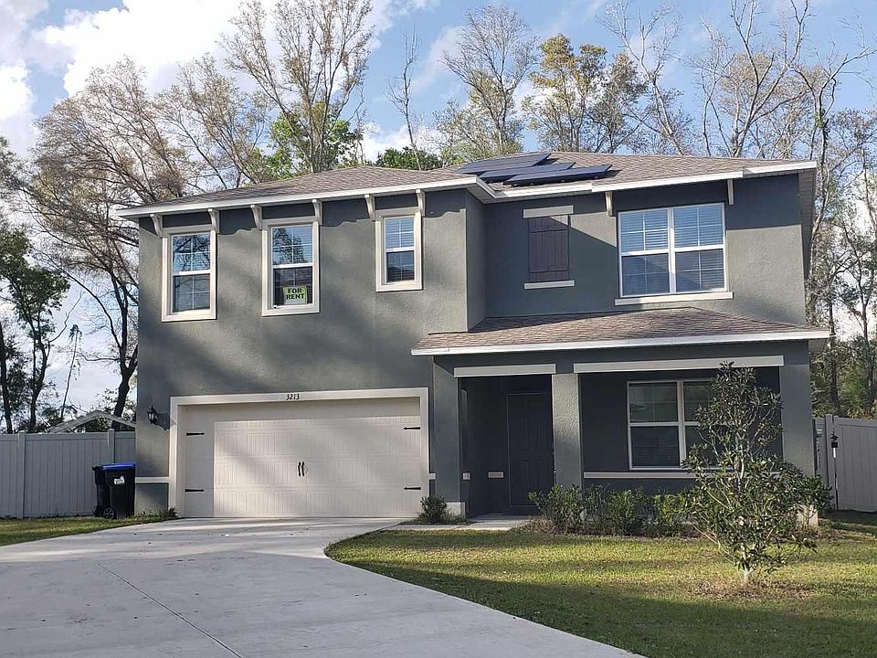 Front of the House with Vinyl Fencing all around the house, which includes double doors access!
