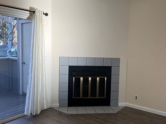 Living room fireplace, balcony with storage unit visible