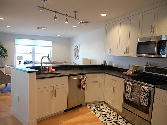 Large kitchen overlooking living room & bar