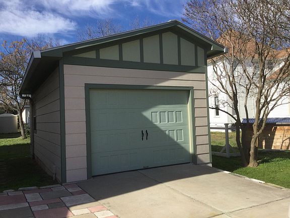 Detached garage with shop space, parking for apx 3 cars on driveway.