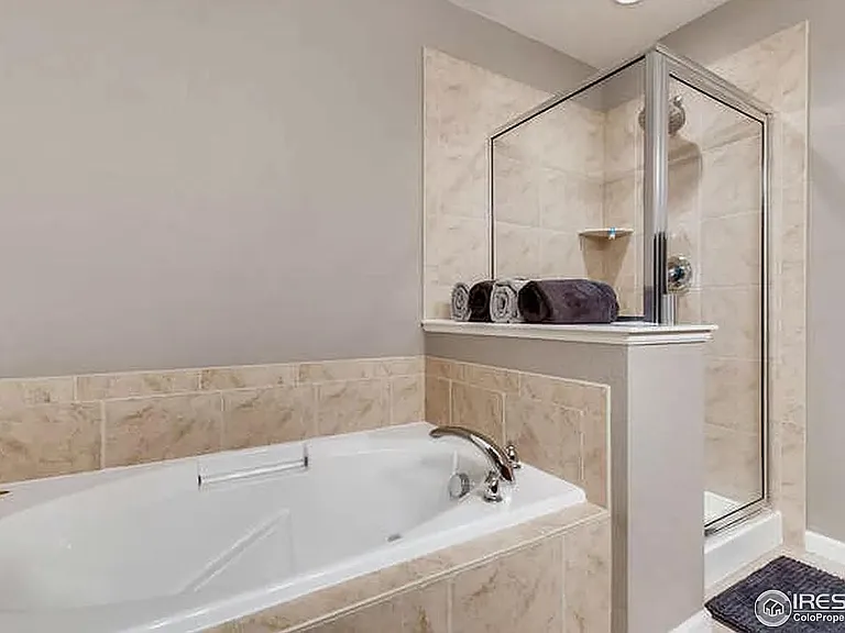 Separate shower and soaking tub in primary bathroom