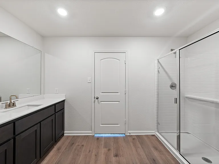 The master bathroom has a glass, walk-in shower.