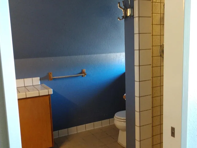 Bathroom tile shower on right