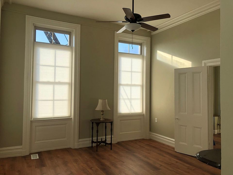 Living room south windows; bedroom door to right.