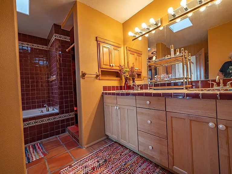 Master bathroom with 2 skylights and window, spa tub and separate shower