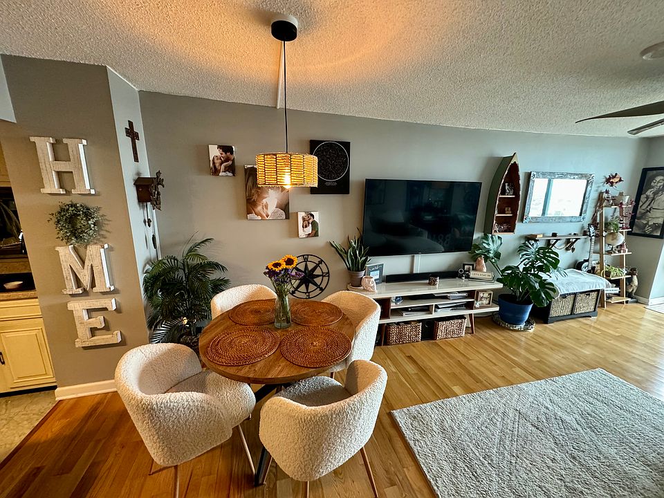 View of the kitchen table, under a new light fixture. Mounted TV on wall really opened up the space!