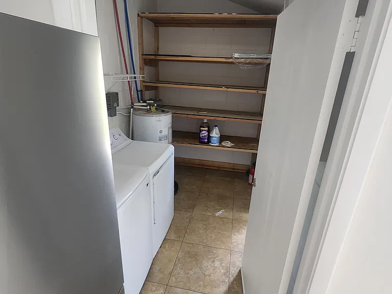 Spacious laundry room with storage.