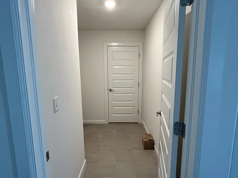 Hallway to laundry room and garage.
