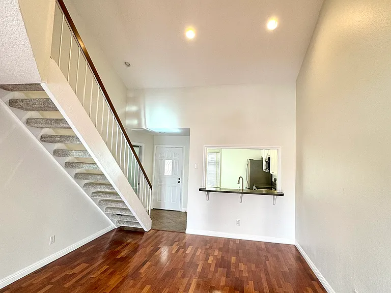 Living room, stairs to extra bedroom in the loft.